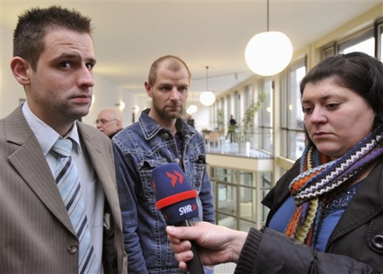 Bjoern B., left, and Markus S., stepsons of Detlef S., and B.'s wife Nadja, give interviews outside the courtroom in Koblenz, Germany on Tuesday. A 48-year-old German admitted to sexually abusing his daughter on Wednesday.